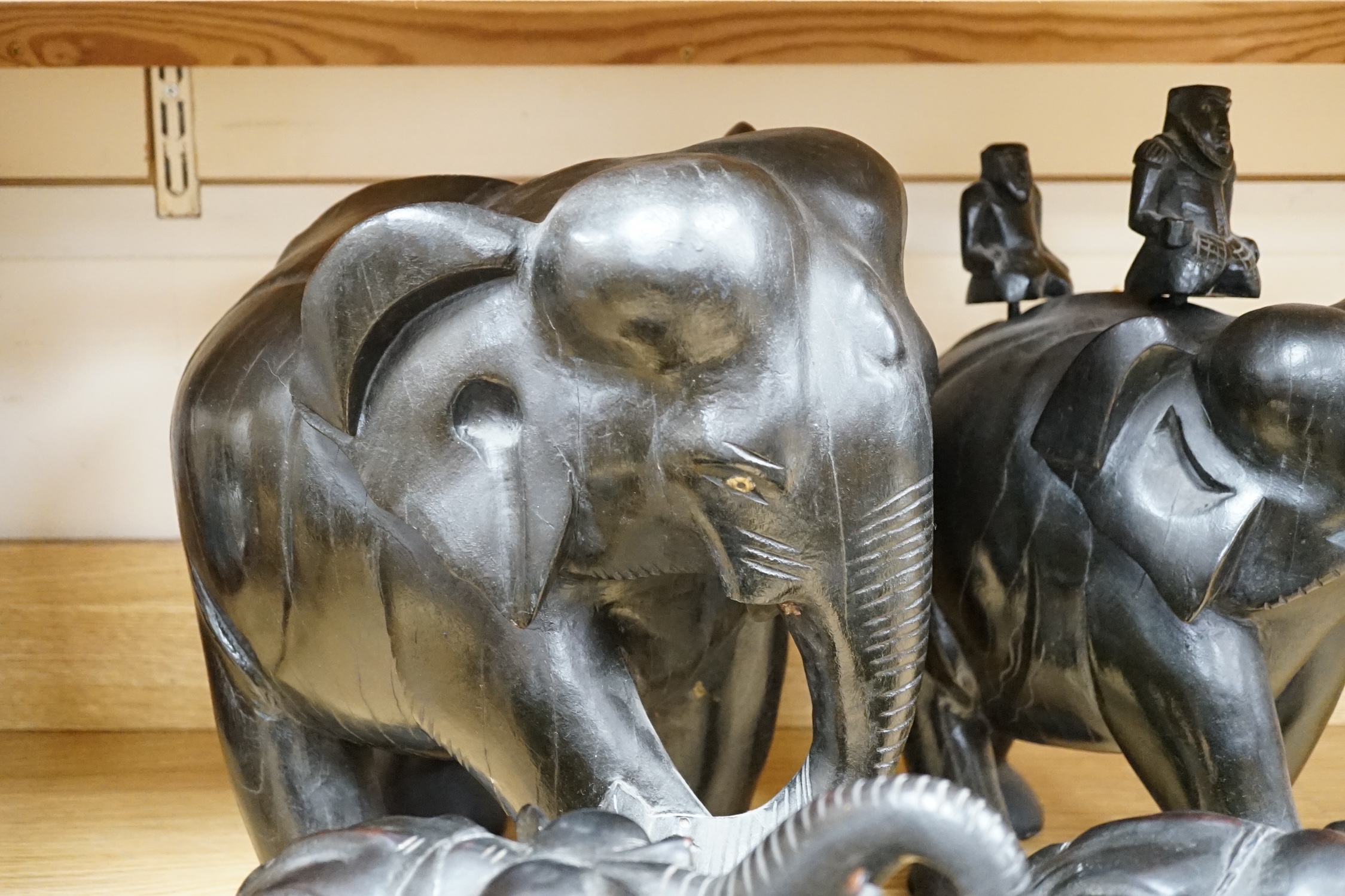 Two large carved ebony elephants and two smaller similar elephants